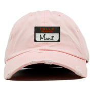 on the front of the hello my name is mami pink distressed dad hat, there is a hello my name is mami name tag logo embroidered on the front