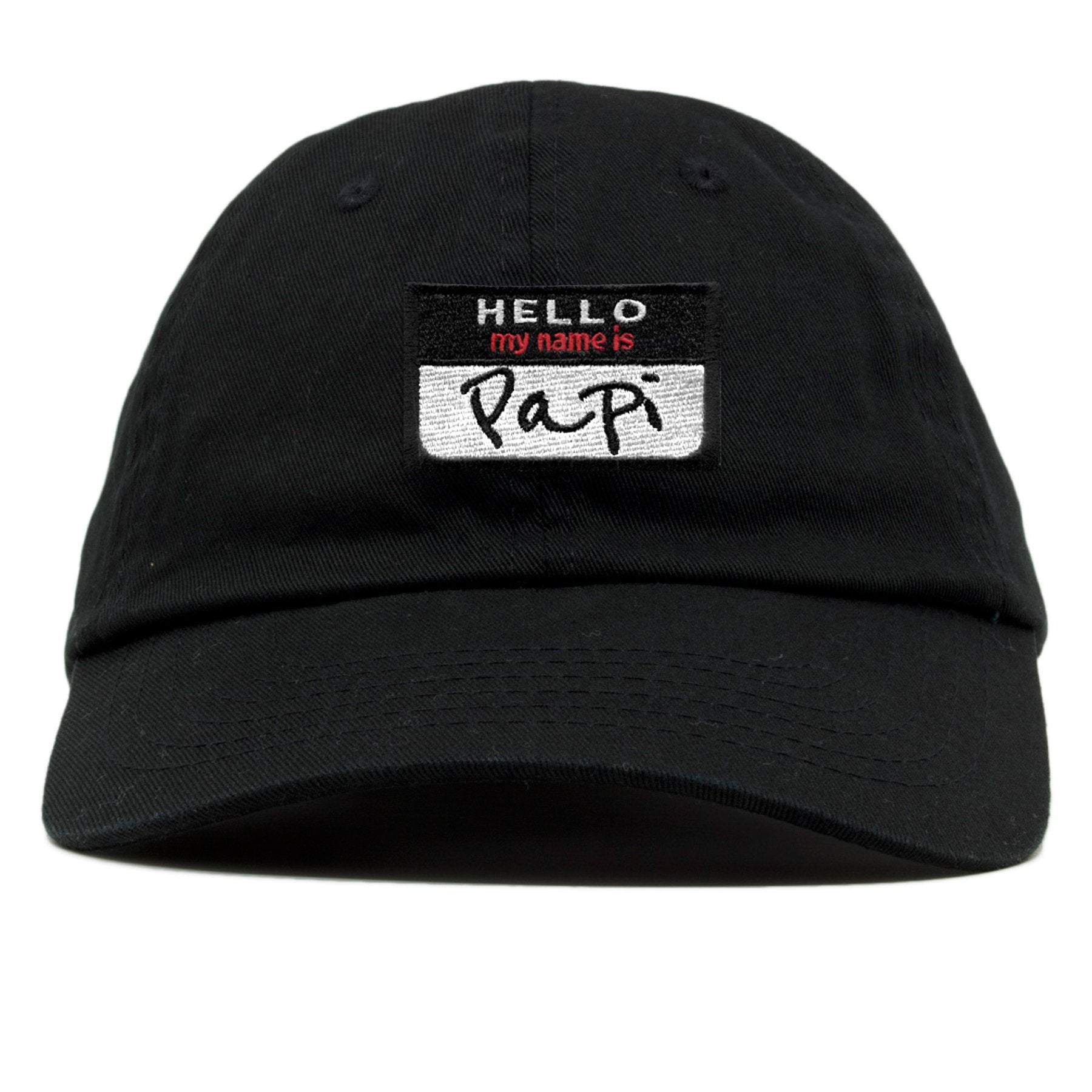 on the front of the hello my name is papi black name tag dad hat, it says hello my name is papi on a name tag style logo