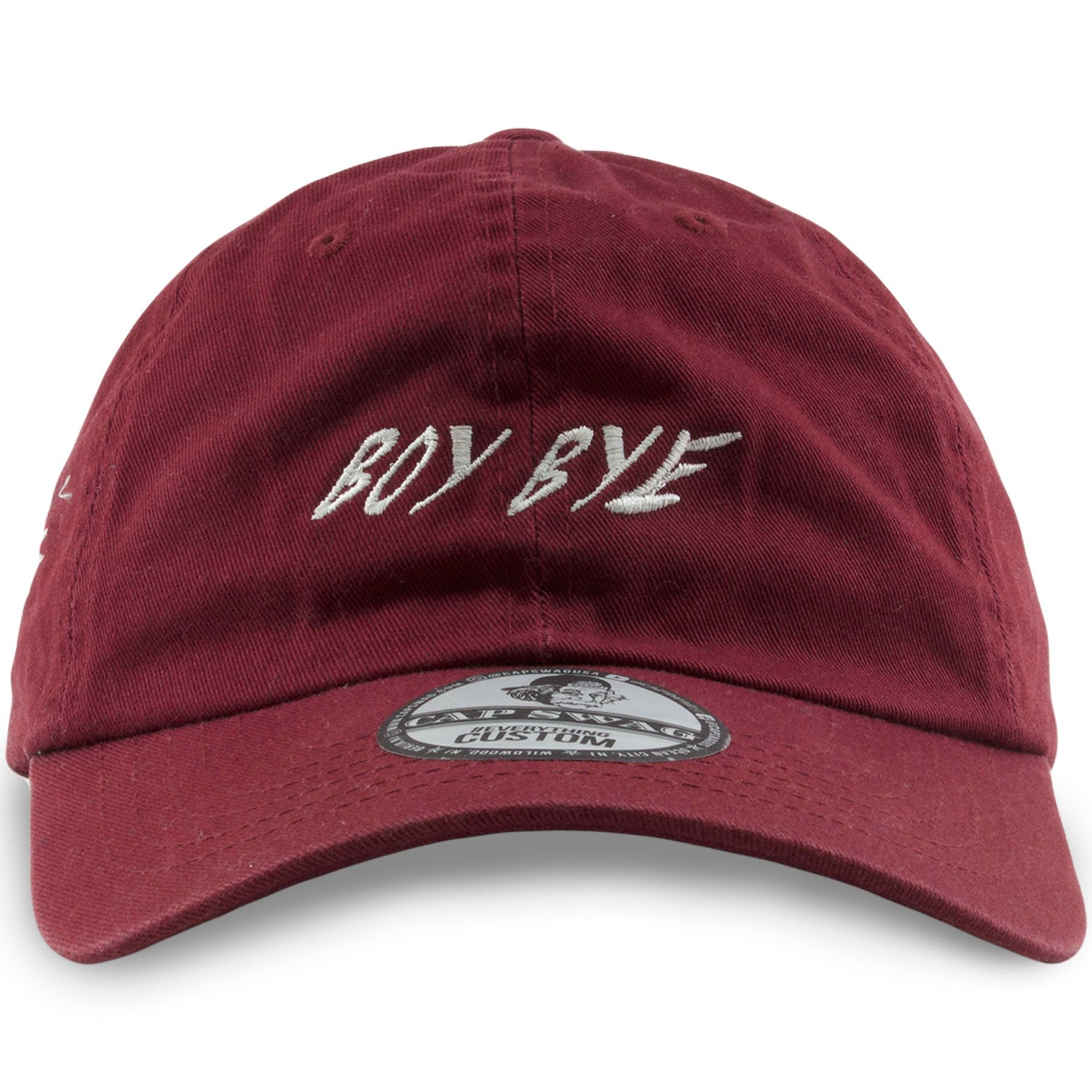 embroidered on the front of the Boy Bye maroon adjustable dad hat is the Boy Bye logo in white script