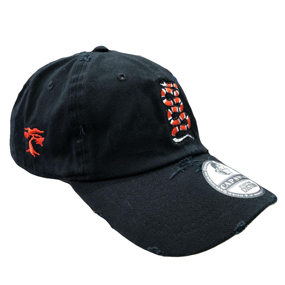 Embroidered on the right side of the rattlesnake black distressed dad hat is a foot clan bonsai tree embroidered in red
