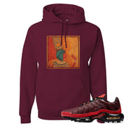 printed on the front of the air max plus sunburst sneaker matching maroon pullover hoodie is the vintage egyptian logo