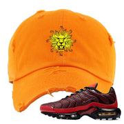 embroidered on the front of the air max plus sunburst sneaker matching orange distressed dad hat is the vintage lion head logo