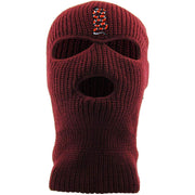 Embroidered on the forehead of the maroon coiled snake ski mask is the snake logo in red, white, and black