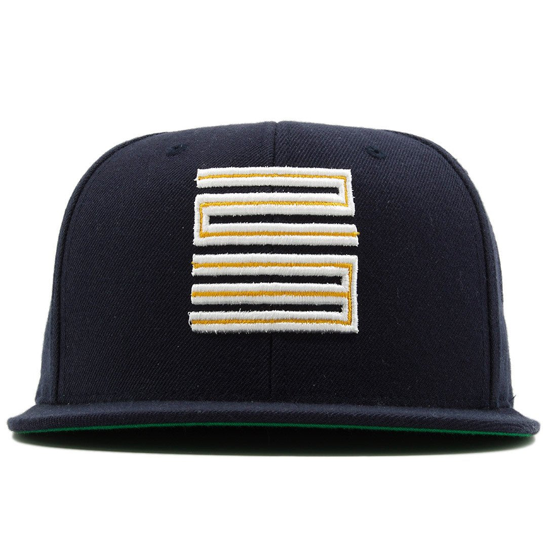 the dunk from above jordan 4 matching snapback hat is navy blue with a yellow and white logo on the front
