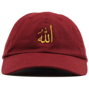 The maroon Allah dad hat features the word Allah written in arabic embroidered on the front in metallic gold thread.
