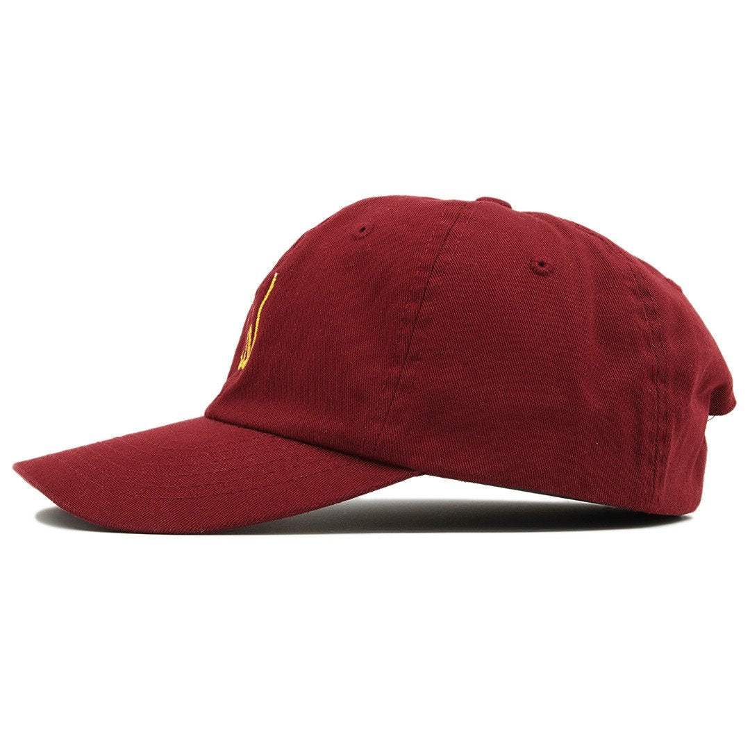 The maroon Allah dad hat has a soft unstructured crown and a bent brim.
