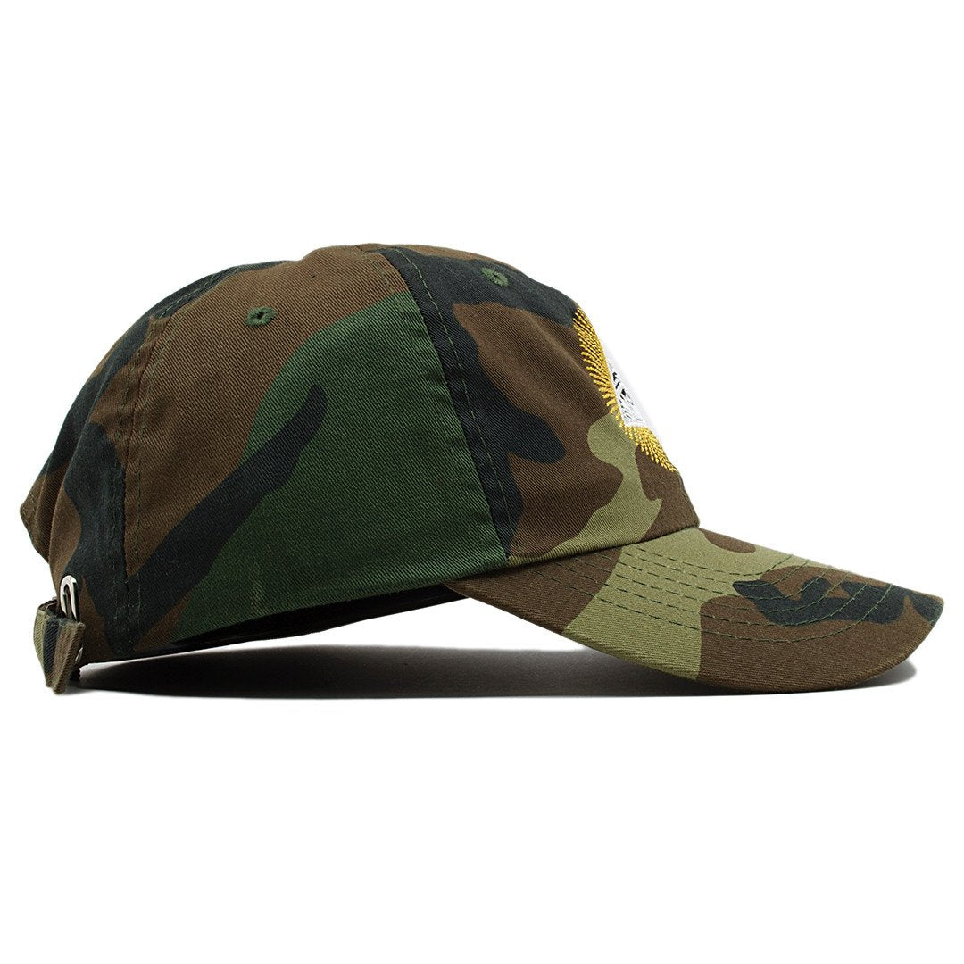 The Illuminati All Seeing Eye dad hat is camouflage and features an unstructured crown with bent brim.
