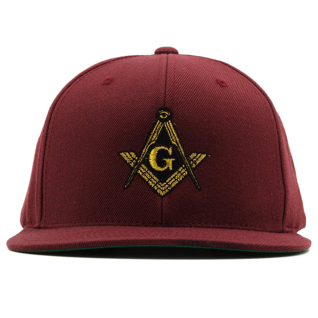 the masonic illuminati snapback hat is maroon has a gold and black logo