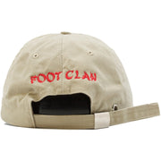 The Foot Clan Bonsai Tree Rising Sun Dad Hat has an adjustable strap with metal clasp. The word "Foot Clan" is embroidered in red into the back of the dad hat.