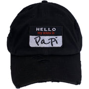 on the front of the hello my name is papi distressed black name tag dad hat, it says hello my name is papi embroidered in black, white, and red