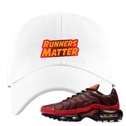 embroidered on the front of the air max plus sunburst white sneaker matching dad hat is the runners matter logo