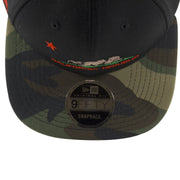 the black on camouflage California Republic snapback hat has a green, black, and brown woodland camouflage patterned brim