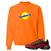 printed on the front of the air max plus sunburst sneaker matching safety orange crewneck sweatshirt is the sunburst soda logo