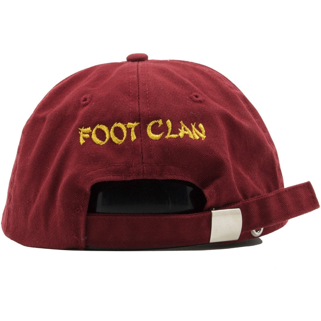 The back of the Illuminati Free Mason dad hat has the words " Foot Clan" embroidered in gold.